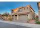 Charming two-story home features desert landscaping, a tile roof, and an attached two-car garage at 10306 Coastline Creek Ct, Las Vegas, NV 89141