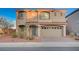 Charming two-story home features desert landscaping, a tile roof, and an attached two-car garage at 10306 Coastline Creek Ct, Las Vegas, NV 89141