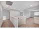 Bright hallway featuring neutral carpet and white walls, leading to multiple rooms, creating an airy, open feel at 10306 Coastline Creek Ct, Las Vegas, NV 89141