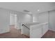 Hallway leading to bedrooms, featuring neutral carpeting and freshly painted walls at 10306 Coastline Creek Ct, Las Vegas, NV 89141