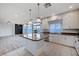 Bright kitchen with a large island, sleek white cabinets, and stainless steel appliances at 10306 Coastline Creek Ct, Las Vegas, NV 89141