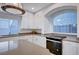 Well-lit kitchen with stainless steel oven, countertops, white cabinets, and a view at 10306 Coastline Creek Ct, Las Vegas, NV 89141