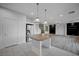 Open concept kitchen featuring stainless steel appliances, a large island, and modern pendant lighting at 10306 Coastline Creek Ct, Las Vegas, NV 89141