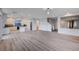 Open concept living space with modern lighting fixtures and an adjacent kitchen area at 10306 Coastline Creek Ct, Las Vegas, NV 89141