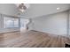 Open-concept living room with wood floors, modern light fixture, and easy access to other rooms at 10306 Coastline Creek Ct, Las Vegas, NV 89141