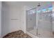 Spacious glass enclosed shower, with tiled walls and a built-in shower seat at 10306 Coastline Creek Ct, Las Vegas, NV 89141
