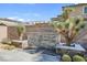 Private backyard with a decorative stone wall, water feature and desert landscaping at 12836 Alcores St, Las Vegas, NV 89141
