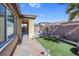 Backyard featuring a covered patio, artificial grass, stone pavers and drought-tolerant landscaping at 12836 Alcores St, Las Vegas, NV 89141