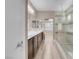Bright, modern bathroom with glass shower, double vanity, and views to the bedroom at 12836 Alcores St, Las Vegas, NV 89141