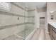 Bathroom with a spacious glass-enclosed shower and light wood-look flooring at 12836 Alcores St, Las Vegas, NV 89141