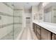 Contemporary bathroom showcasing a glass shower, double vanity and wood-look flooring at 12836 Alcores St, Las Vegas, NV 89141