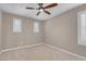 Bedroom with neutral walls, carpet and two windows with plantation shutters at 12836 Alcores St, Las Vegas, NV 89141