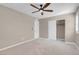 Neutral bedroom featuring plush carpeting, a ceiling fan, and a sliding-door closet at 12836 Alcores St, Las Vegas, NV 89141