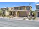 Inviting two-story home with desert landscaping, a two car garage and neutral color palette at 12836 Alcores St, Las Vegas, NV 89141