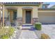 Charming home entrance with a stone facade, paver walkway, and drought tolerant landscaping at 12836 Alcores St, Las Vegas, NV 89141