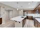 Bright kitchen featuring a large island with seating, stainless steel appliances, and ample cabinet space at 12836 Alcores St, Las Vegas, NV 89141