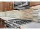 Close up of a gas range and a tile backsplash in a modern and well equipped kitchen space at 12836 Alcores St, Las Vegas, NV 89141