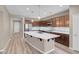 Gourmet kitchen featuring a large island, stainless steel appliances, modern lighting, and neutral tones at 12836 Alcores St, Las Vegas, NV 89141