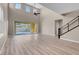 Bright living room features wood floors, high ceilings with fan, and sliding glass doors to the backyard at 12836 Alcores St, Las Vegas, NV 89141