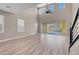 Bright living room features wood floors, high ceilings with fan, and sliding glass doors to the backyard at 12836 Alcores St, Las Vegas, NV 89141