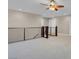An airy loft area with railing and ceiling fan at 12836 Alcores St, Las Vegas, NV 89141