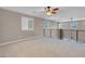 Spacious loft area with modern black railing, ceiling fan, and natural light at 12836 Alcores St, Las Vegas, NV 89141