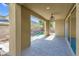 The covered patio has stone flooring and a view of the landscaped backyard at 12836 Alcores St, Las Vegas, NV 89141