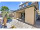 Covered patio features stone flooring, with a view of a landscaped backyard at 12836 Alcores St, Las Vegas, NV 89141