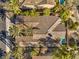 An aerial view of the terracotta tile roof of a property with a pool, mature trees, and desert landscaping at 1477 Foothills Village Dr, Henderson, NV 89012
