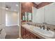 Bathroom featuring double sink vanity with decorative tile and bronze fixtures at 1477 Foothills Village Dr, Henderson, NV 89012