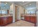 Bathroom featuring dual sinks, large mirrors, and mosaic tile accents at 1477 Foothills Village Dr, Henderson, NV 89012