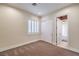 Neutral bedroom with plush carpet, window with plantation shutters, and standard closet at 1477 Foothills Village Dr, Henderson, NV 89012
