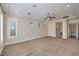 Spacious bedroom featuring carpet floors, ceiling fan, crown molding, and bright windows at 1477 Foothills Village Dr, Henderson, NV 89012