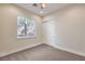 Neutral bedroom with plush carpet, window with view, and standard closet at 1477 Foothills Village Dr, Henderson, NV 89012