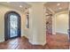 Elegant foyer with tile flooring, arched doorways, and a decorative wrought-iron door at 1477 Foothills Village Dr, Henderson, NV 89012