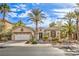Charming single-story home with well-manicured landscaping and desert accents, including palm trees at 1477 Foothills Village Dr, Henderson, NV 89012