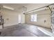Clean, spacious two car garage featuring a large window, storage capabilities, and an automatic door opener at 1477 Foothills Village Dr, Henderson, NV 89012