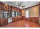 Home office with hardwood floors, custom built-ins, and a window at 1477 Foothills Village Dr, Henderson, NV 89012