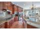 Gourmet kitchen with custom cabinets, granite countertops, and stainless steel appliances at 1477 Foothills Village Dr, Henderson, NV 89012