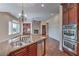 Gourmet kitchen featuring granite countertops, stainless steel appliances, and a stone fireplace at 1477 Foothills Village Dr, Henderson, NV 89012