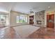 Bright living room featuring a stone fireplace, built-in shelving, and access to the outdoors at 1477 Foothills Village Dr, Henderson, NV 89012