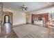 Open-concept space with a stone fireplace, gourmet kitchen, and arched entryway at 1477 Foothills Village Dr, Henderson, NV 89012