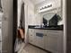 Functional bathroom featuring modern white cabinets, sleek black countertops, and tile flooring for comfort at 2101 Sun Ave, North Las Vegas, NV 89030
