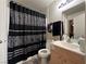 Bathroom featuring a shower with black and white patterned curtain, sink, and mirror at 2101 Sun Ave, North Las Vegas, NV 89030