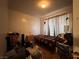 Modest bedroom with single bed, minimal light and disorganized belongings at 2101 Sun Ave, North Las Vegas, NV 89030
