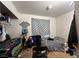 Bedroom with a bed, a window with a curtain, and disorganized items at 2101 Sun Ave, North Las Vegas, NV 89030