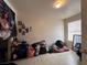 Bedroom with light tile flooring, window, and various items on the floor at 2101 Sun Ave, North Las Vegas, NV 89030