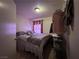 Bedroom featuring neutral colored walls, a bed, and metal shelving on the wall at 2101 Sun Ave, North Las Vegas, NV 89030