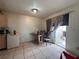 Dining area with tile flooring, a glass top table, and a sliding glass door to the backyard at 2101 Sun Ave, North Las Vegas, NV 89030