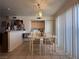 Bright dining area with tile floors, featuring a chandelier and functional storage, next to the kitchen and laundry at 2101 Sun Ave, North Las Vegas, NV 89030